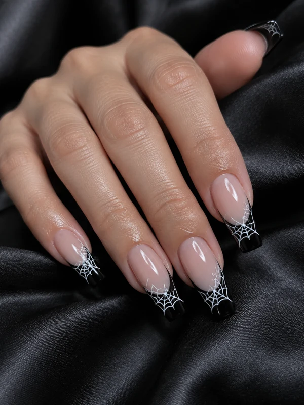 Spider Web Tips: Black French tips with fine white spider web line art over a sheer nude base.